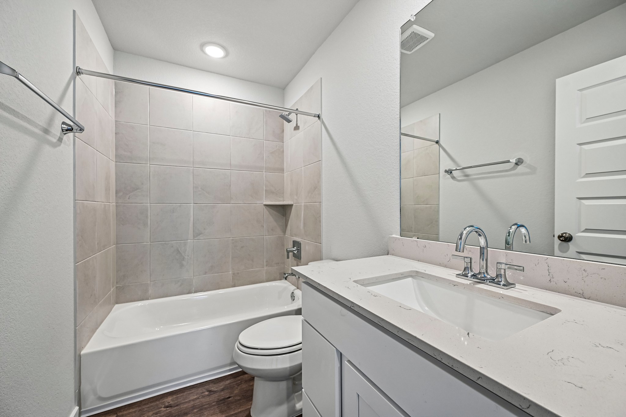 A bathroom with a tub sink and toilet.