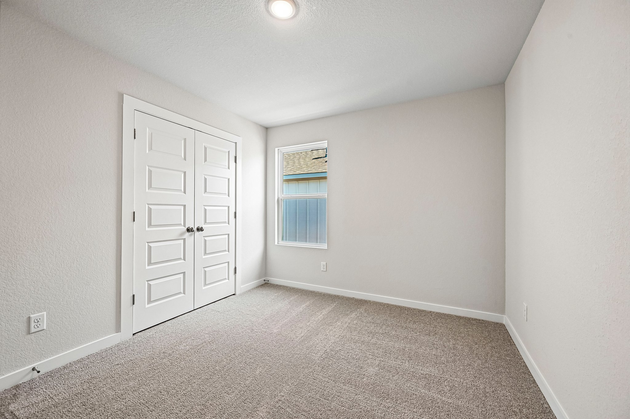 A room with a door and a window.