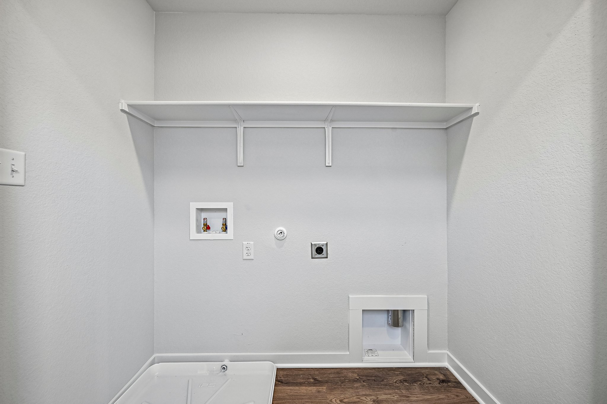 A white wall with a picture on it.