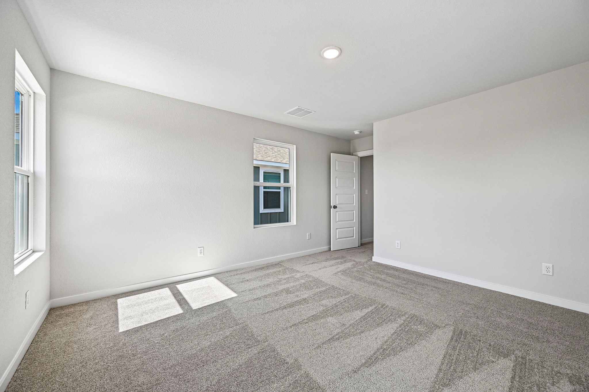 A room with a carpet and a rug.