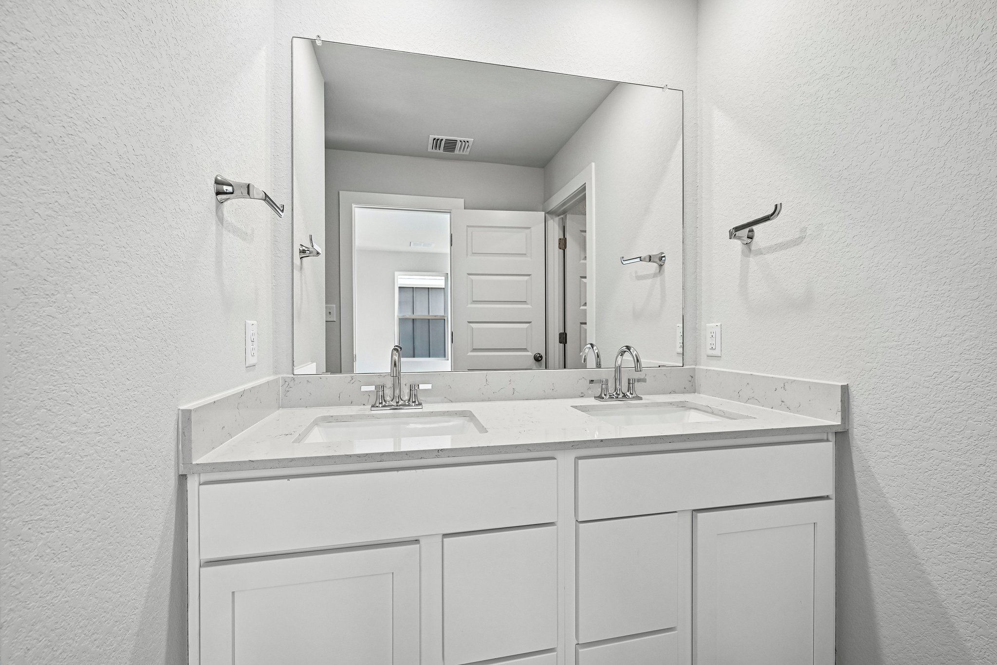 A bathroom with a large mirror.