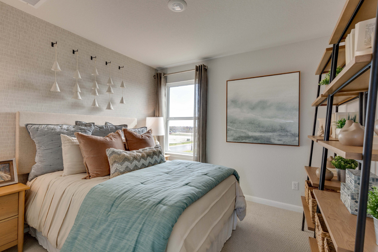 A bedroom with a bed and a shelf.