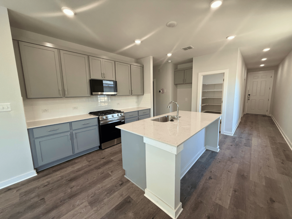 A kitchen with white cabinets.