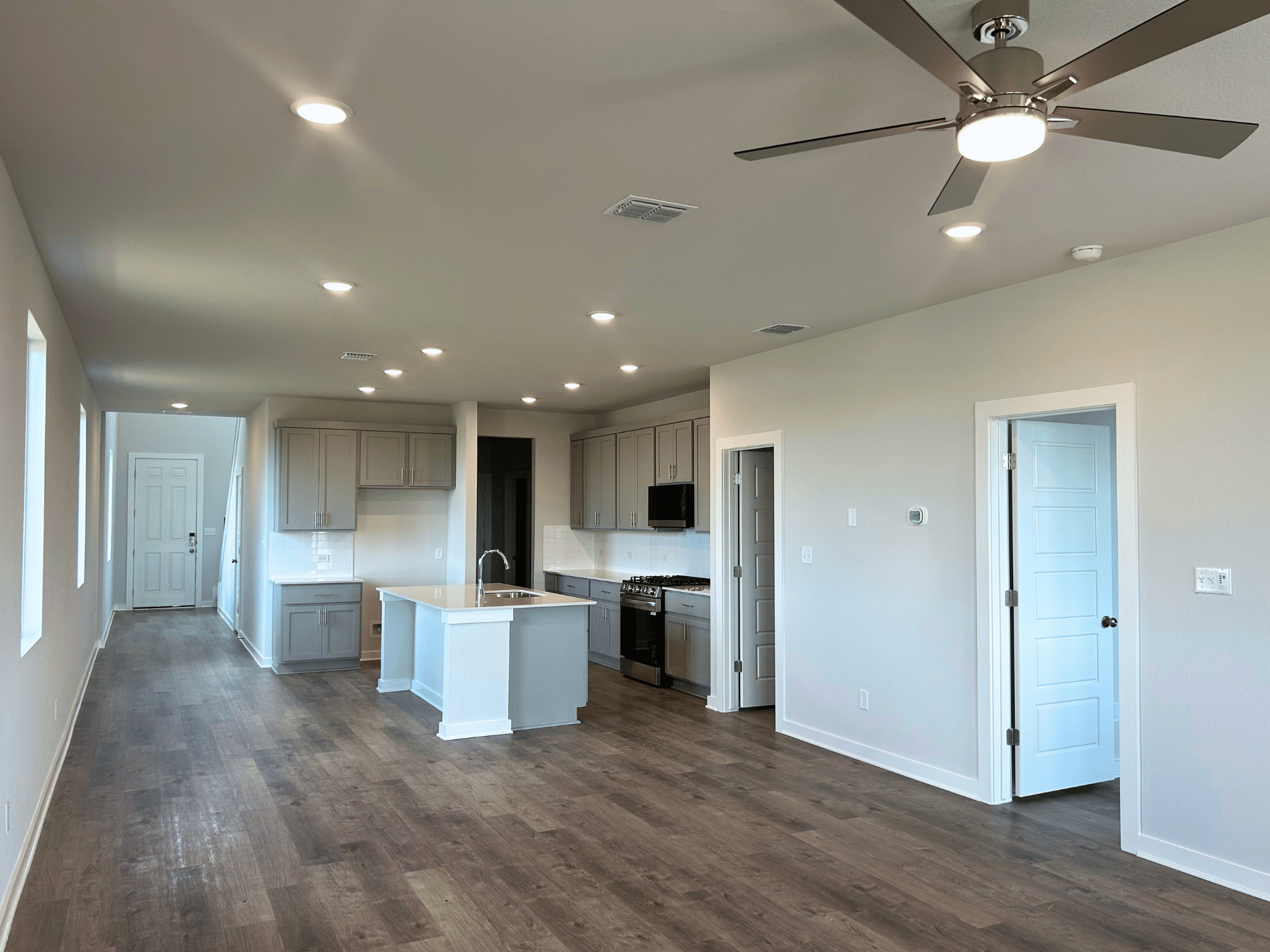 A large kitchen with white walls.