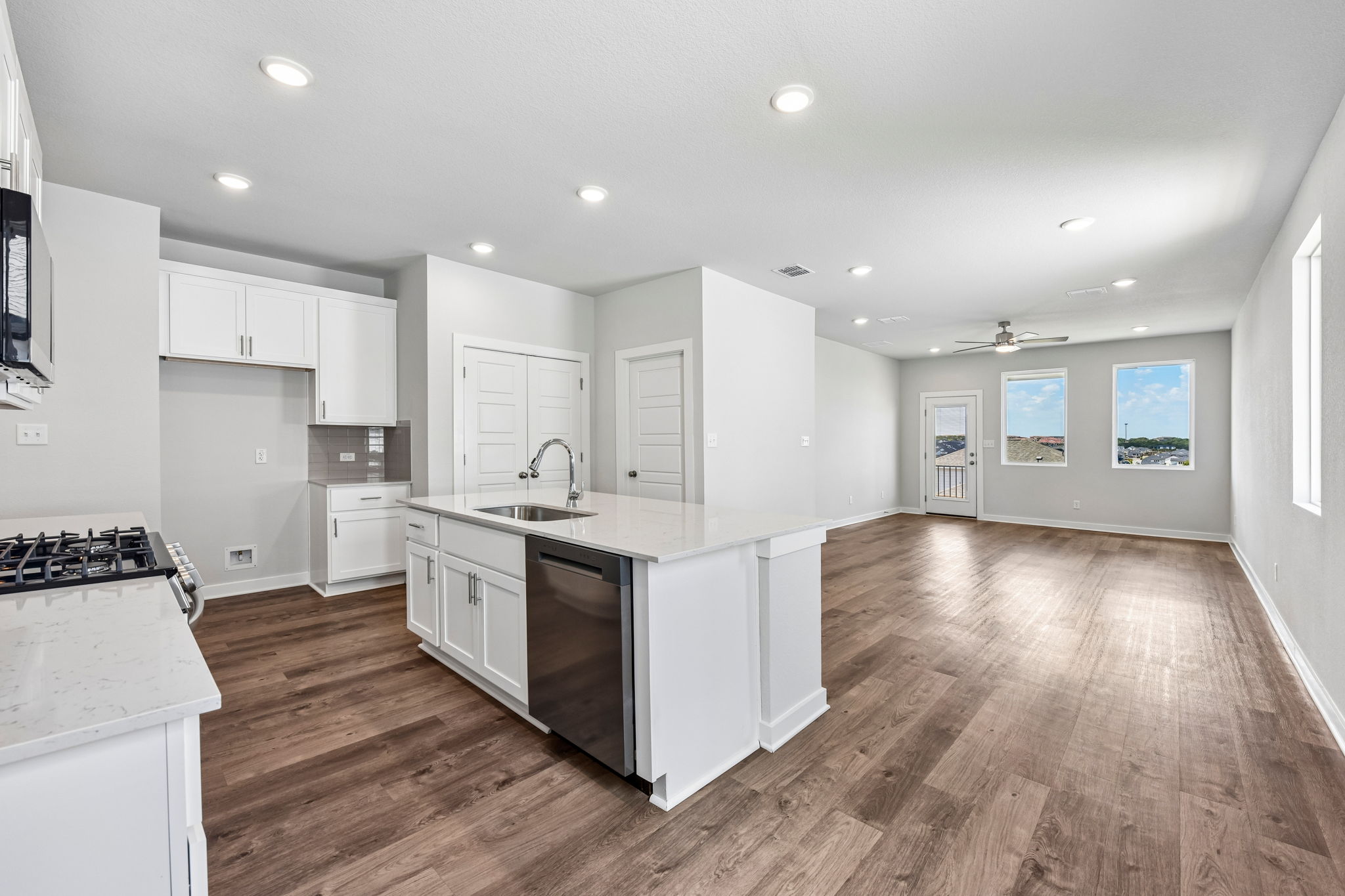 A kitchen with white cabinets.
