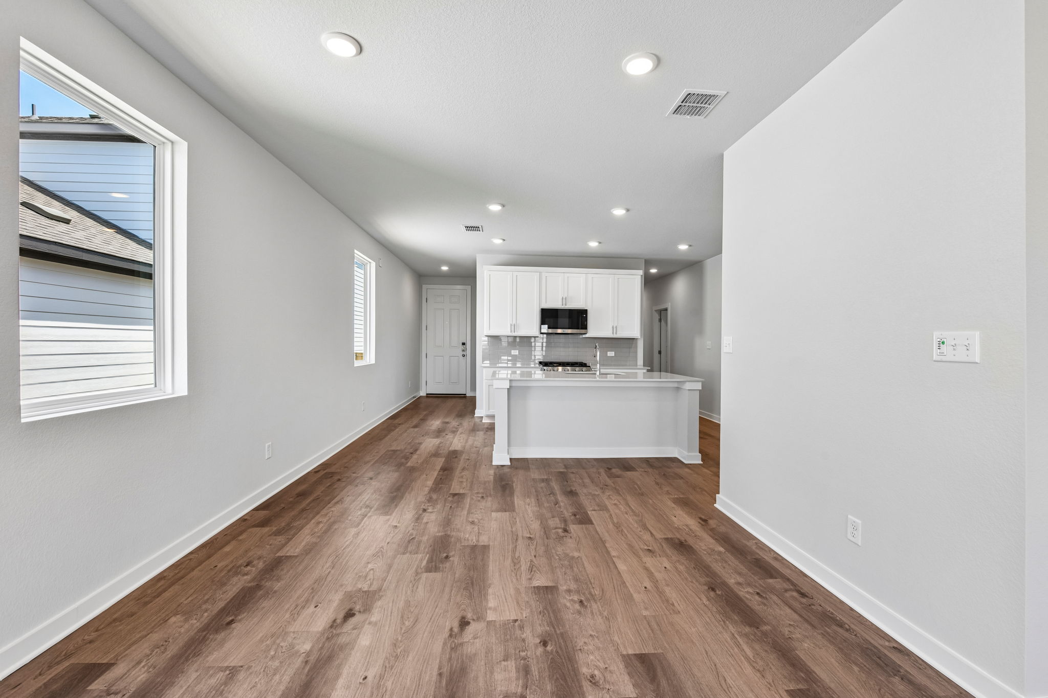 A room with a wood floor and white walls.