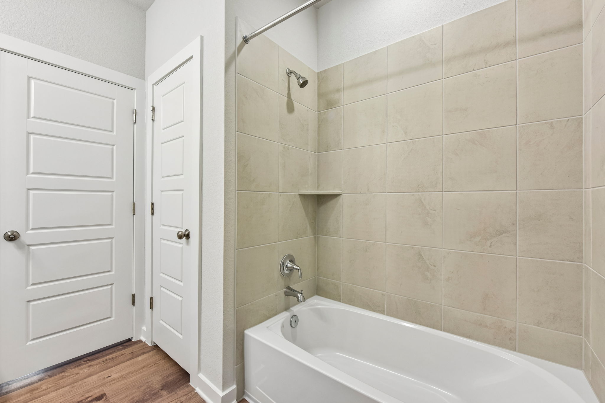 A bathroom with a bathtub and shower.