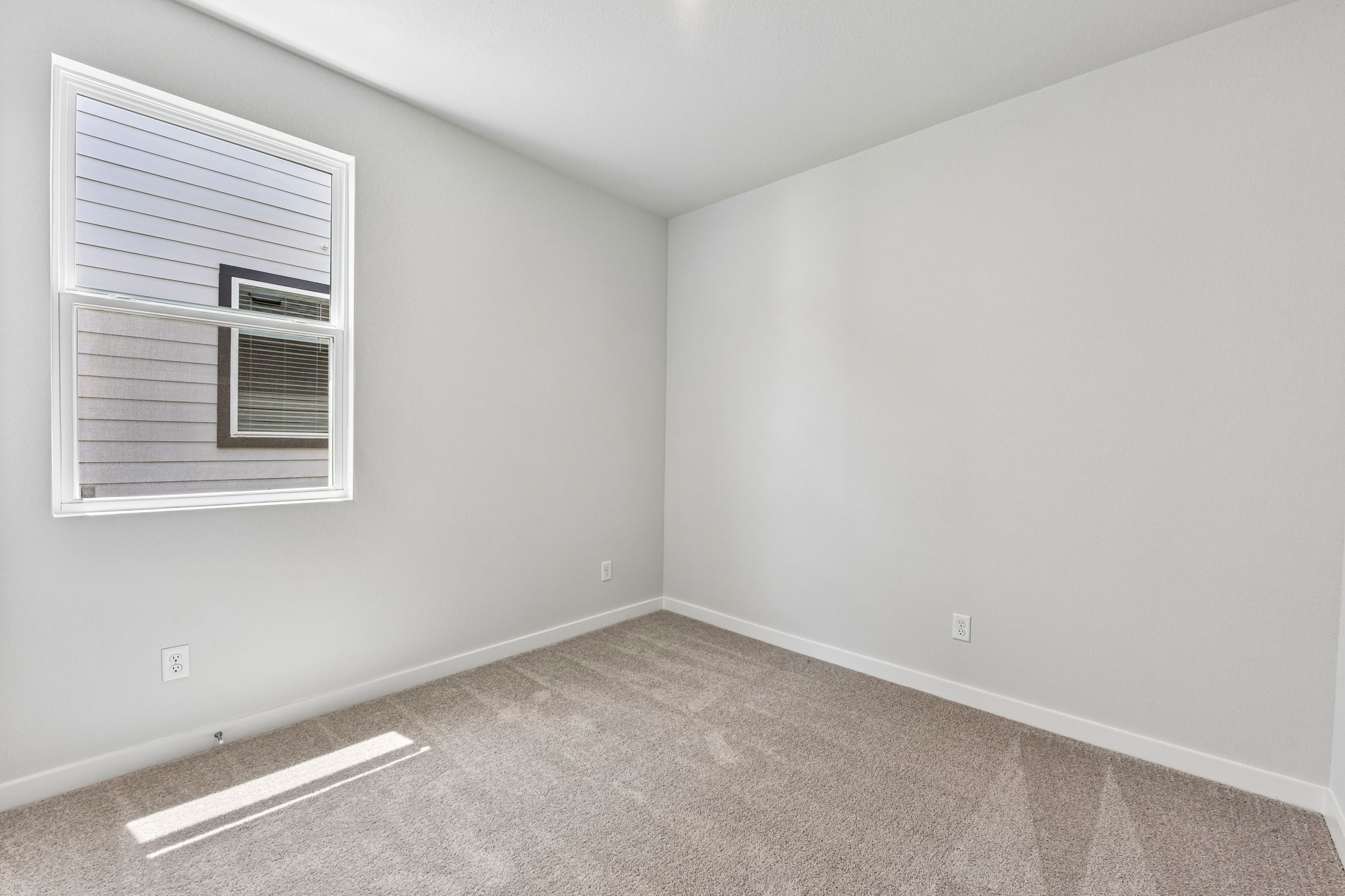 A room with a vent and a window.