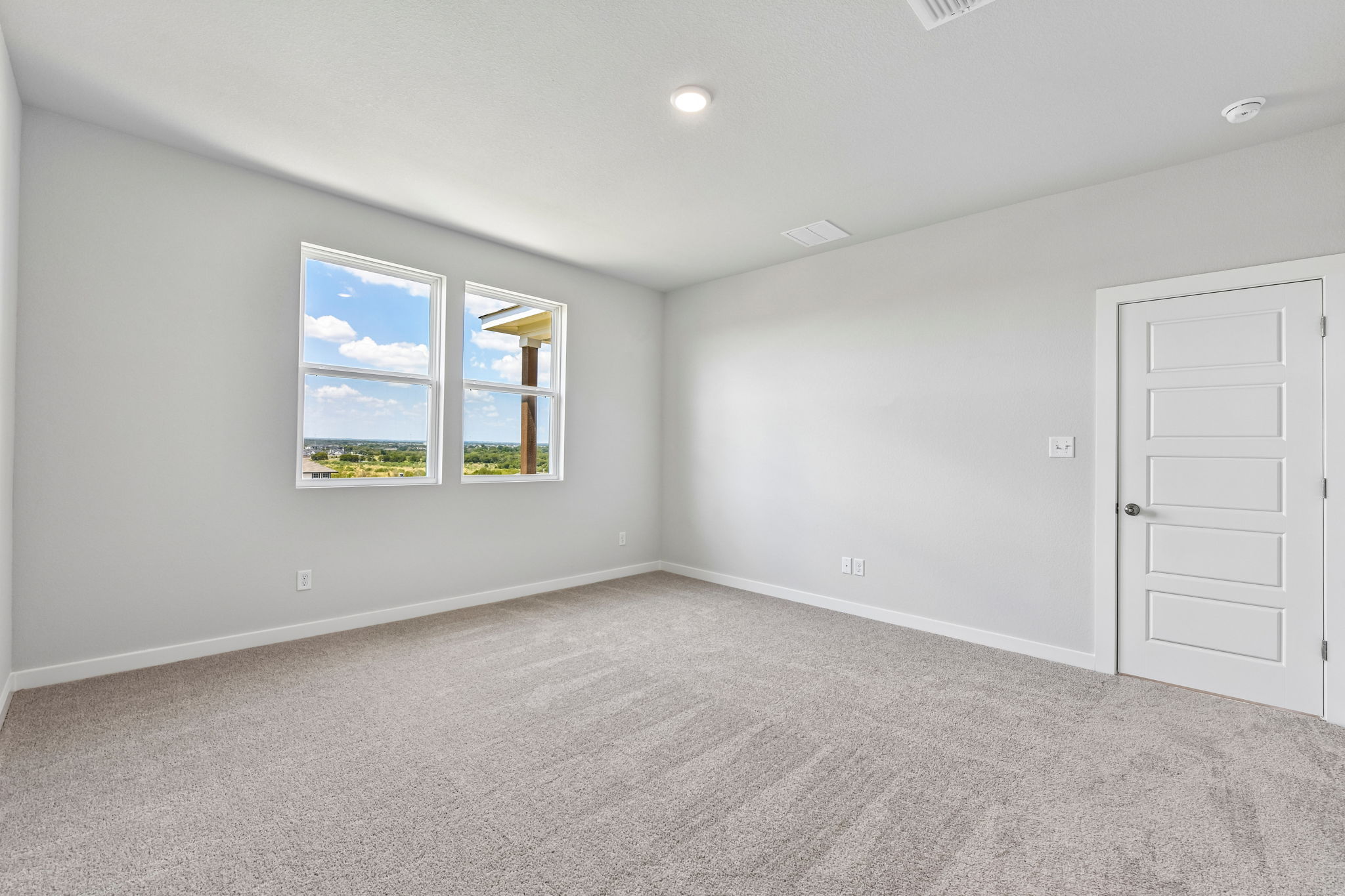 A room with a window and a door.