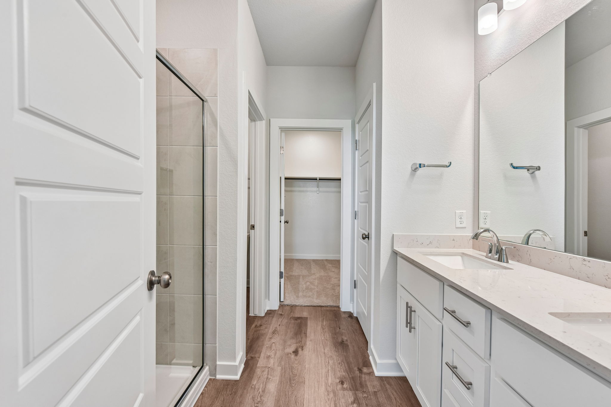 A bathroom with white cabinets.