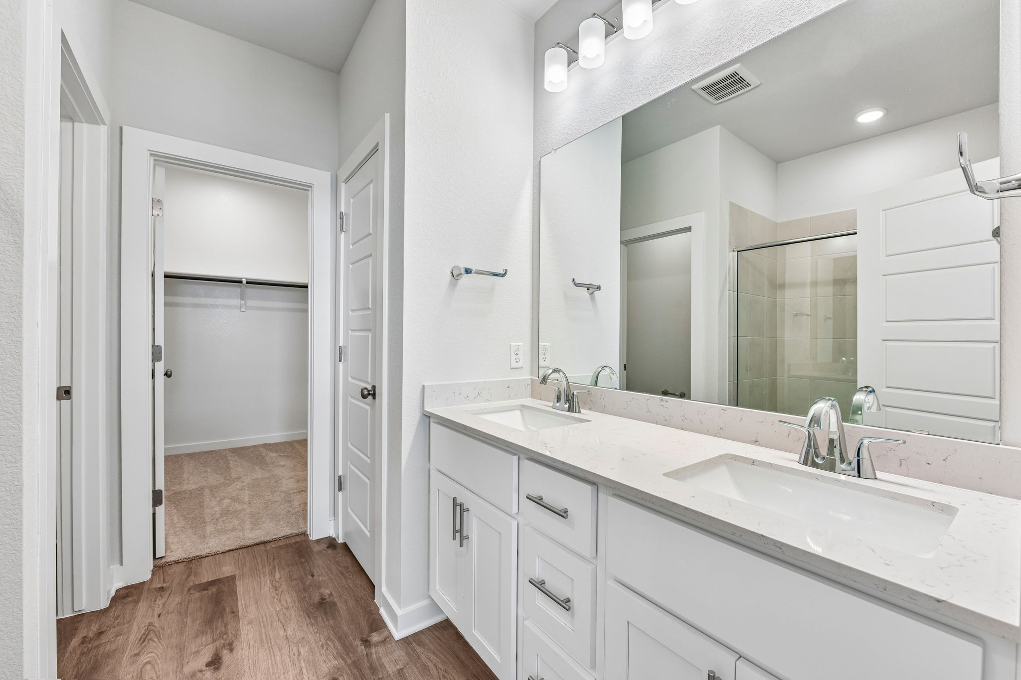 A bathroom with a large mirror.