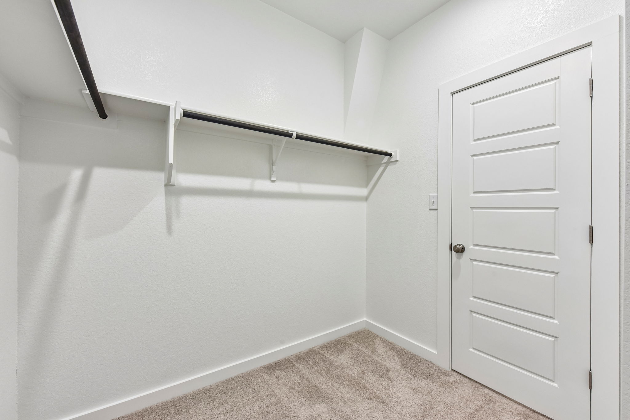 A white room with a white door.
