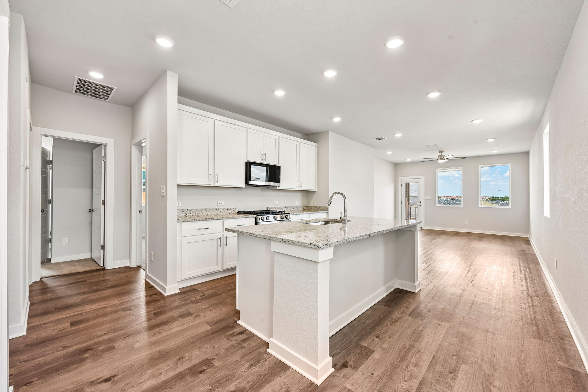 A kitchen with white cabinets.