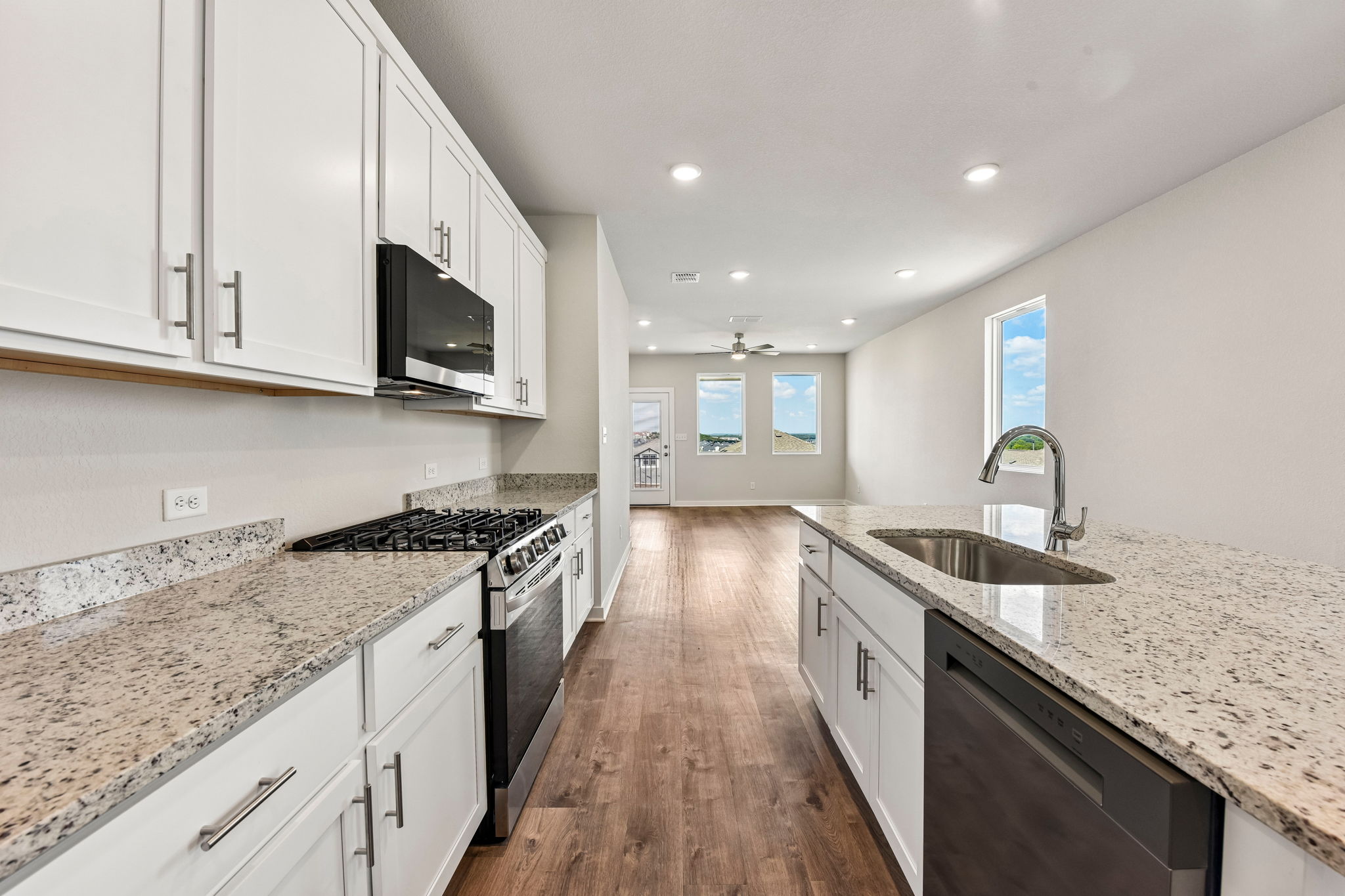 A kitchen with white cabinets.