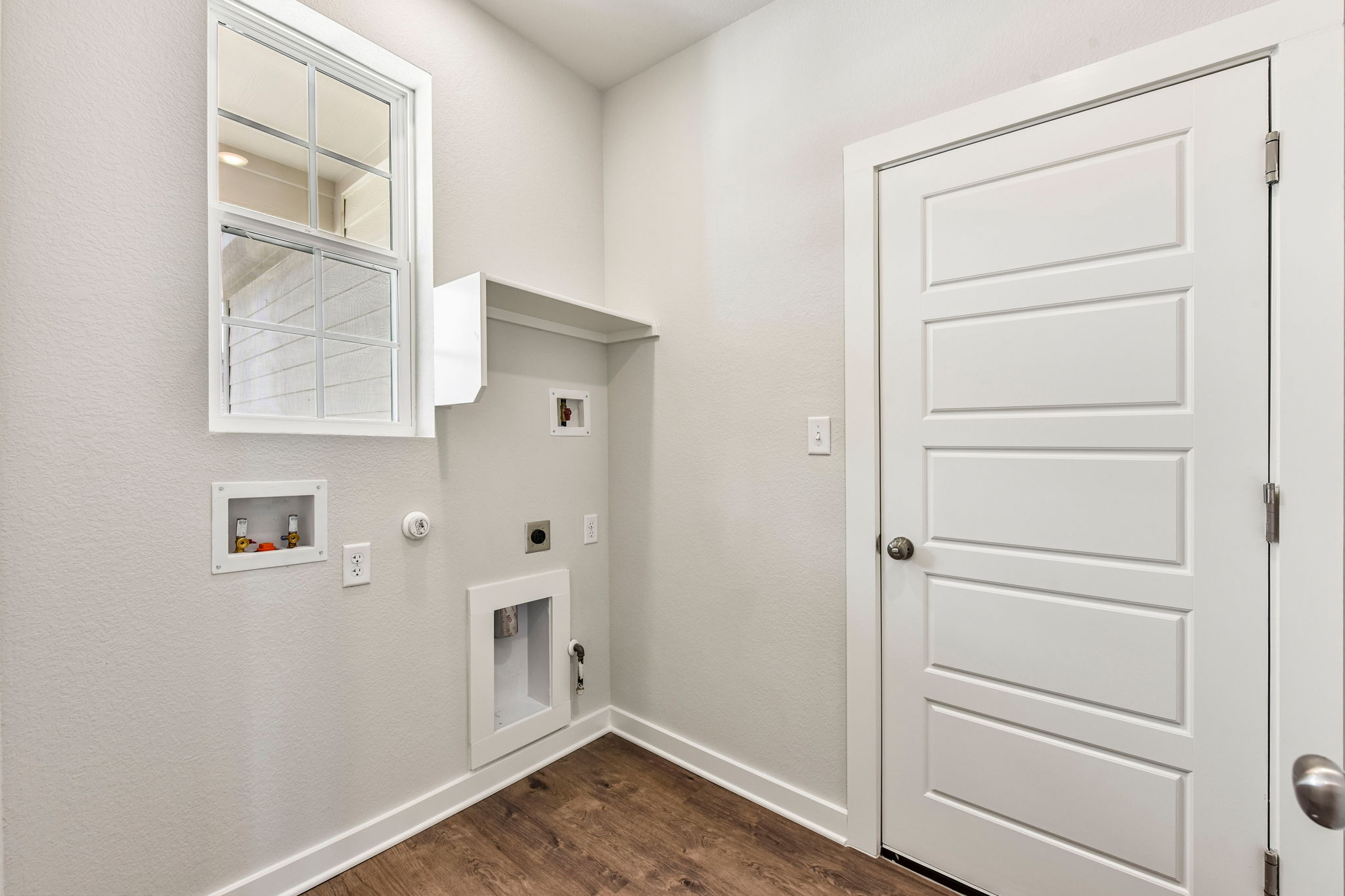 A white room with a white door.