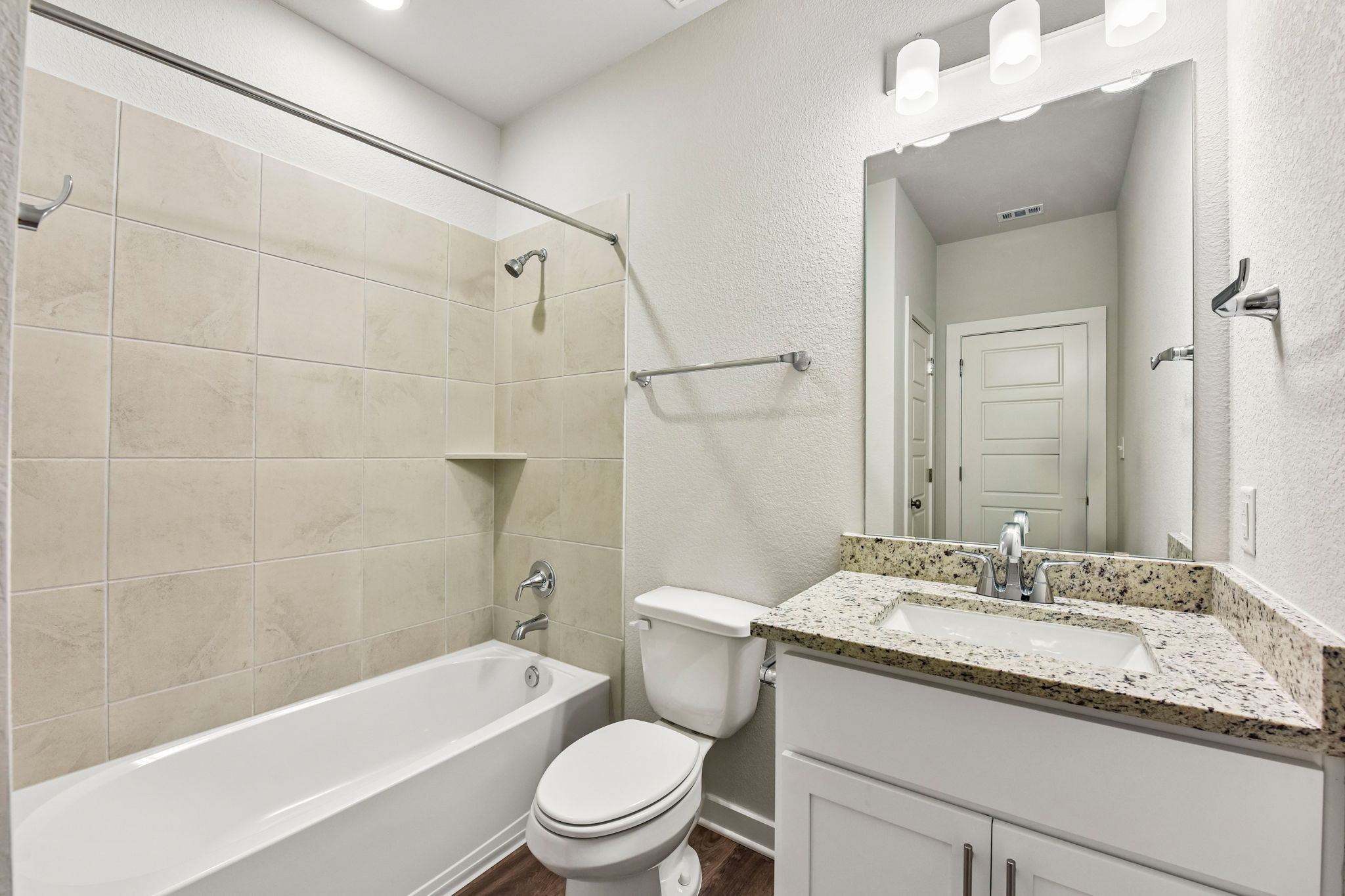 A bathroom with a tub sink and toilet.