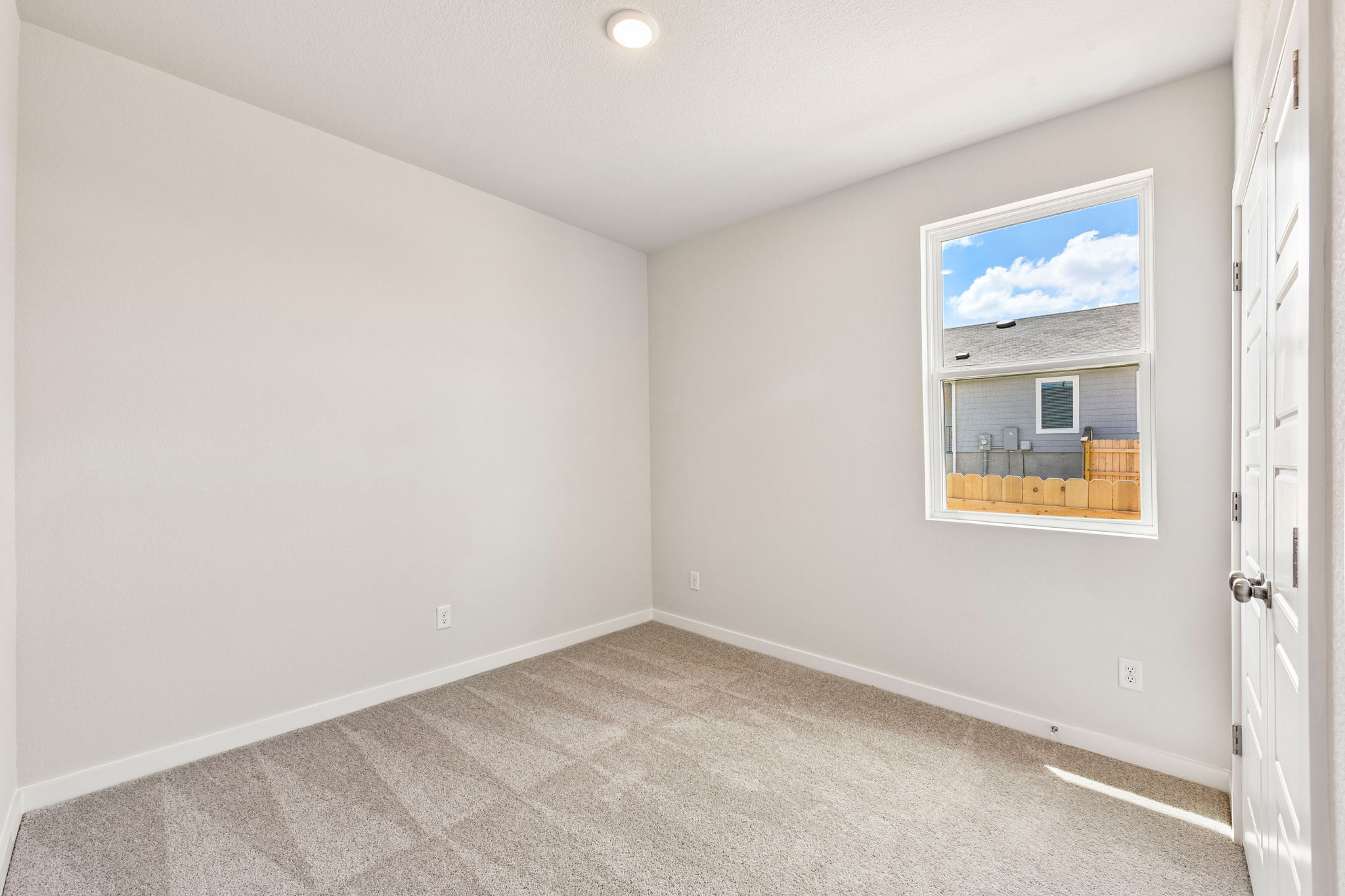 A room with a window and a door.