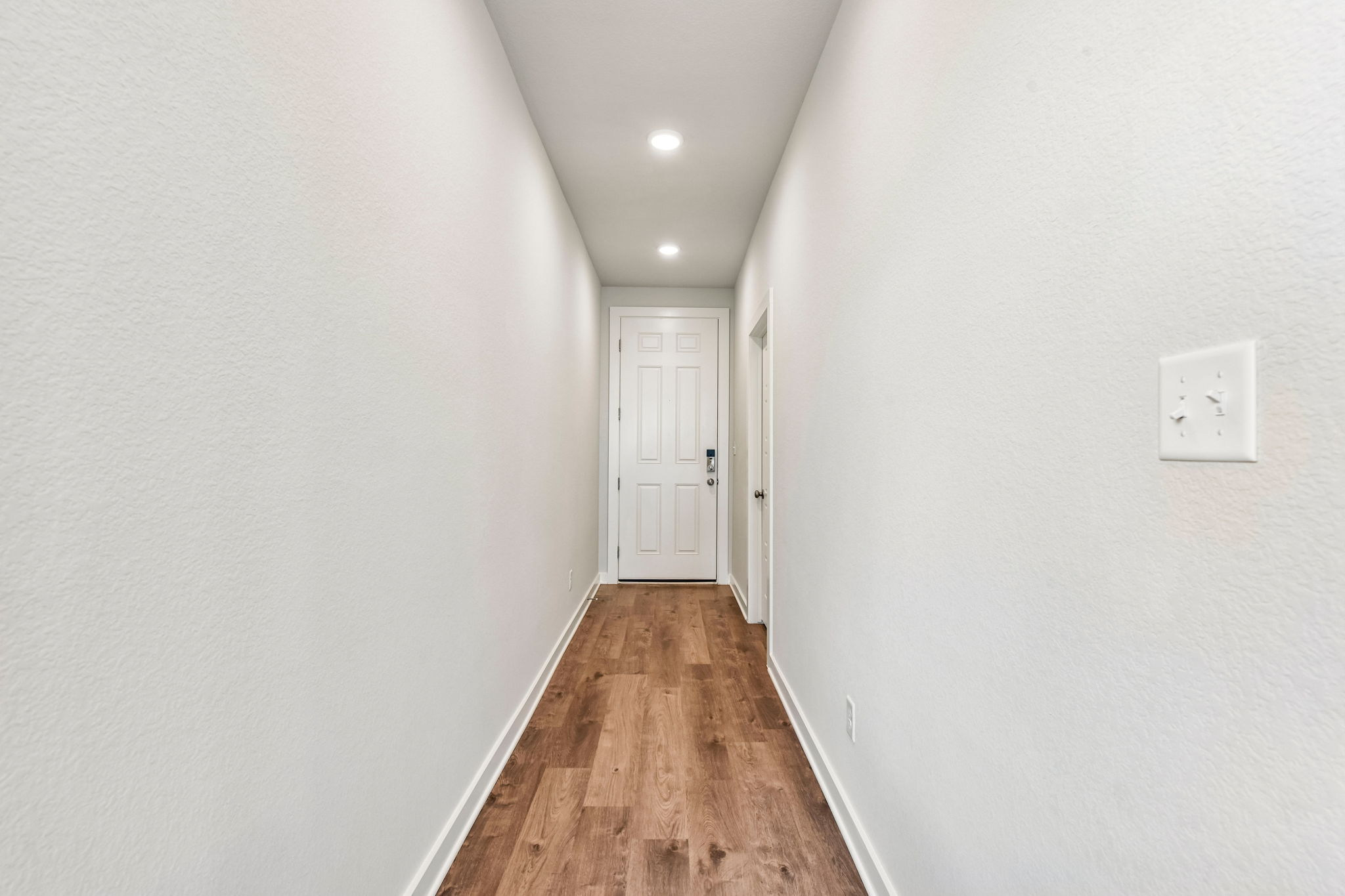 A hallway with white walls.