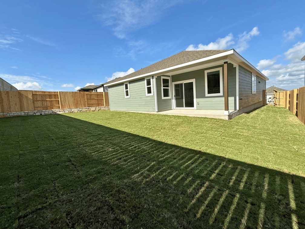 A house with a green lawn.