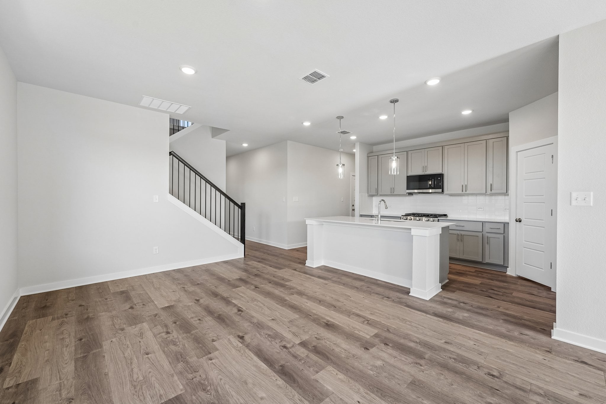 A large kitchen with white cabinets.