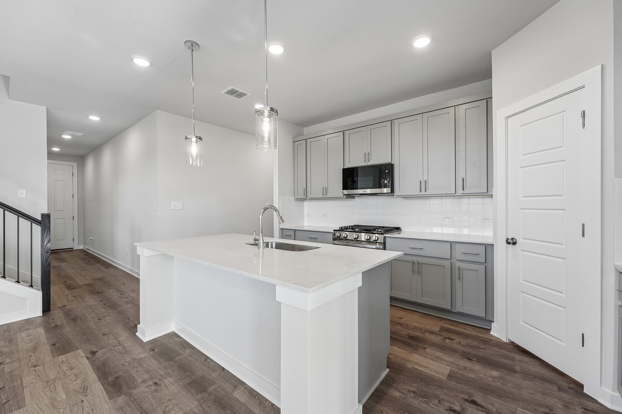 A kitchen with white cabinets.