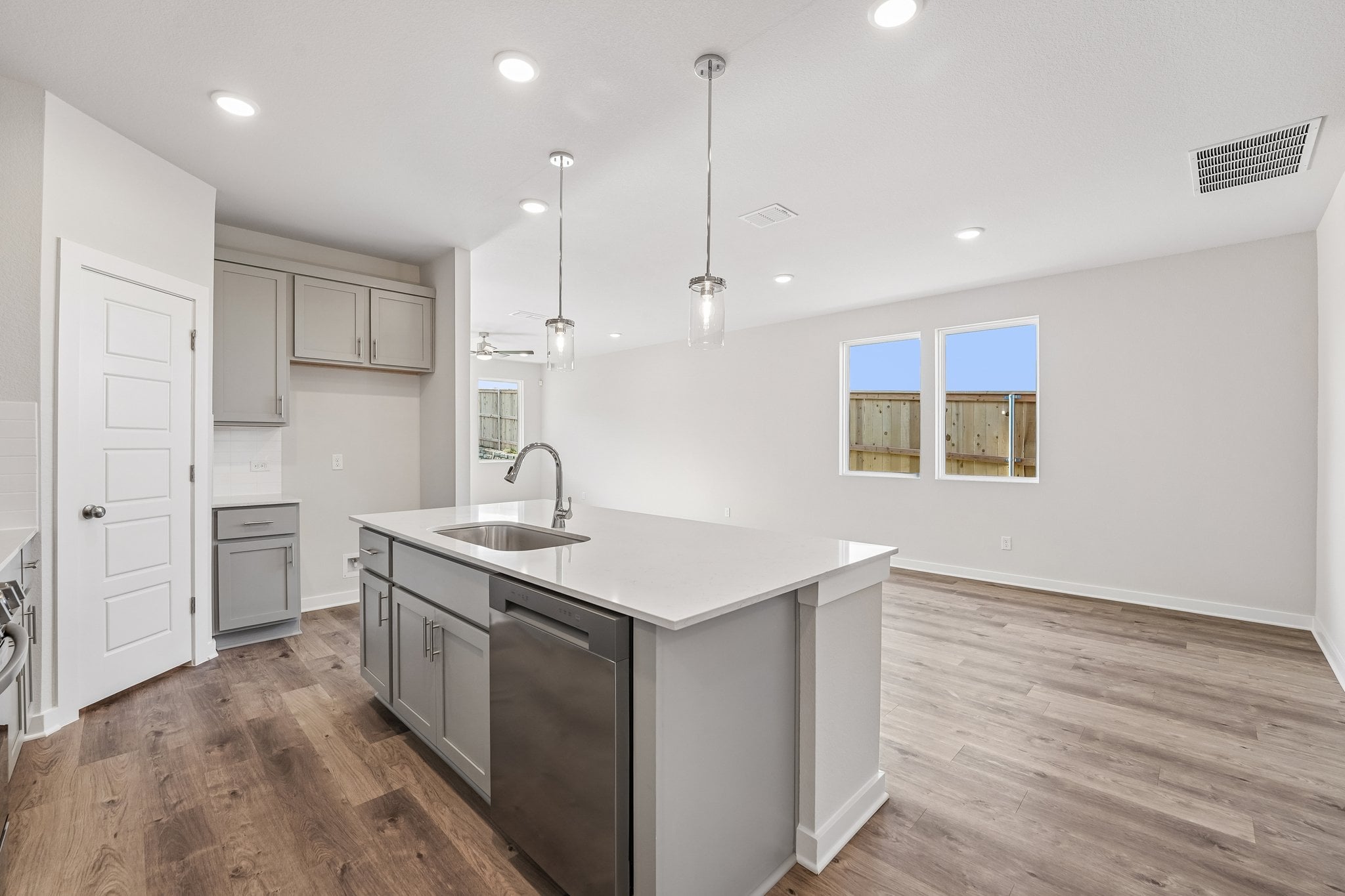 A kitchen with white cabinets.