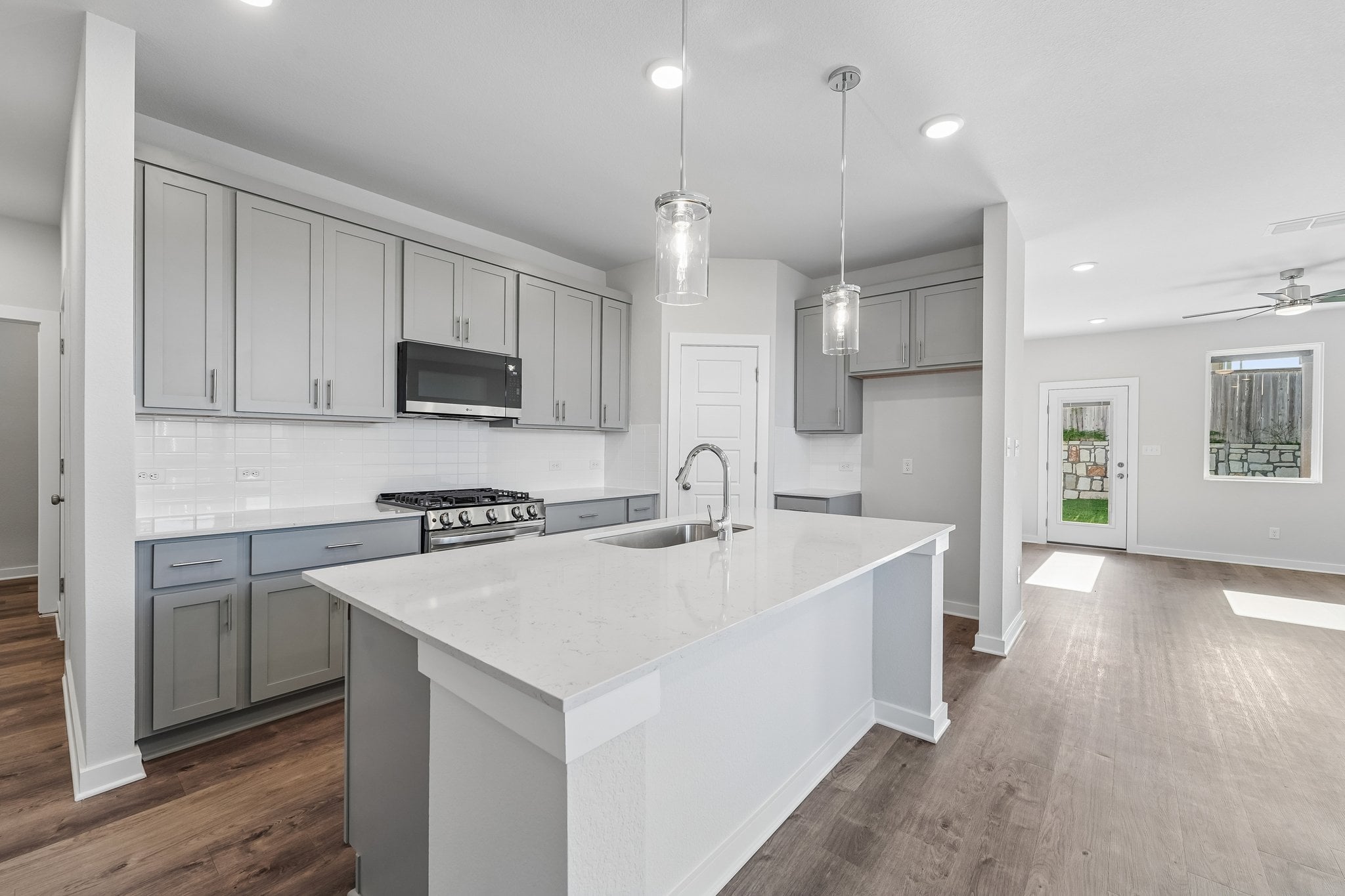 A kitchen with white cabinets.