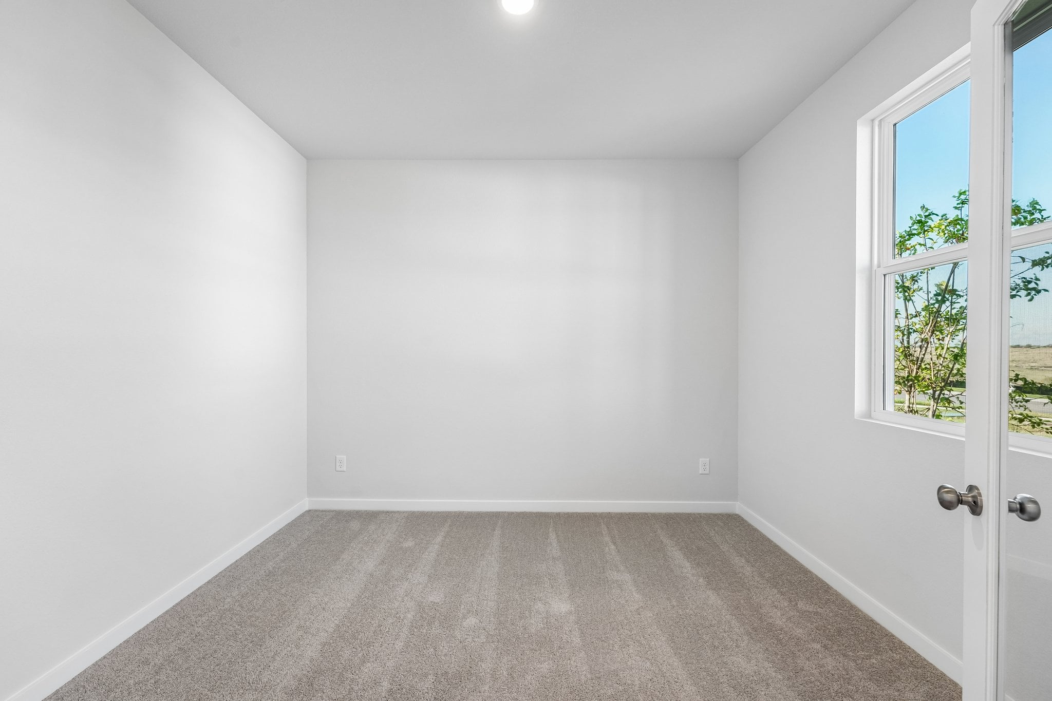 A room with a door and windows.