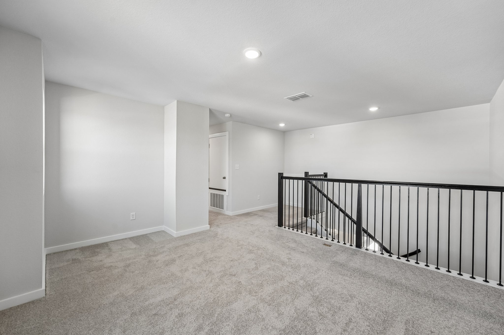 A hallway with a railing.