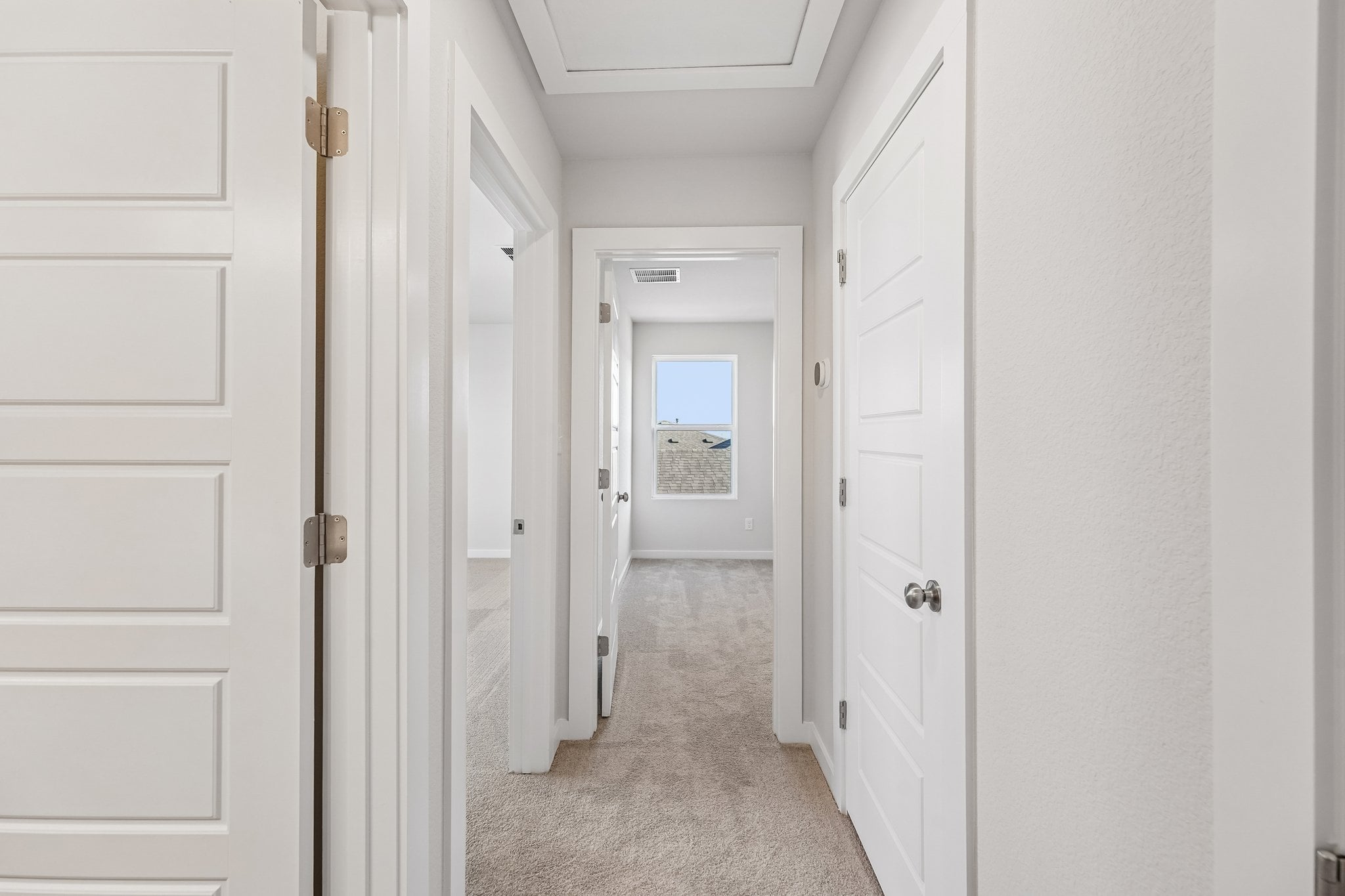A hallway with white doors.