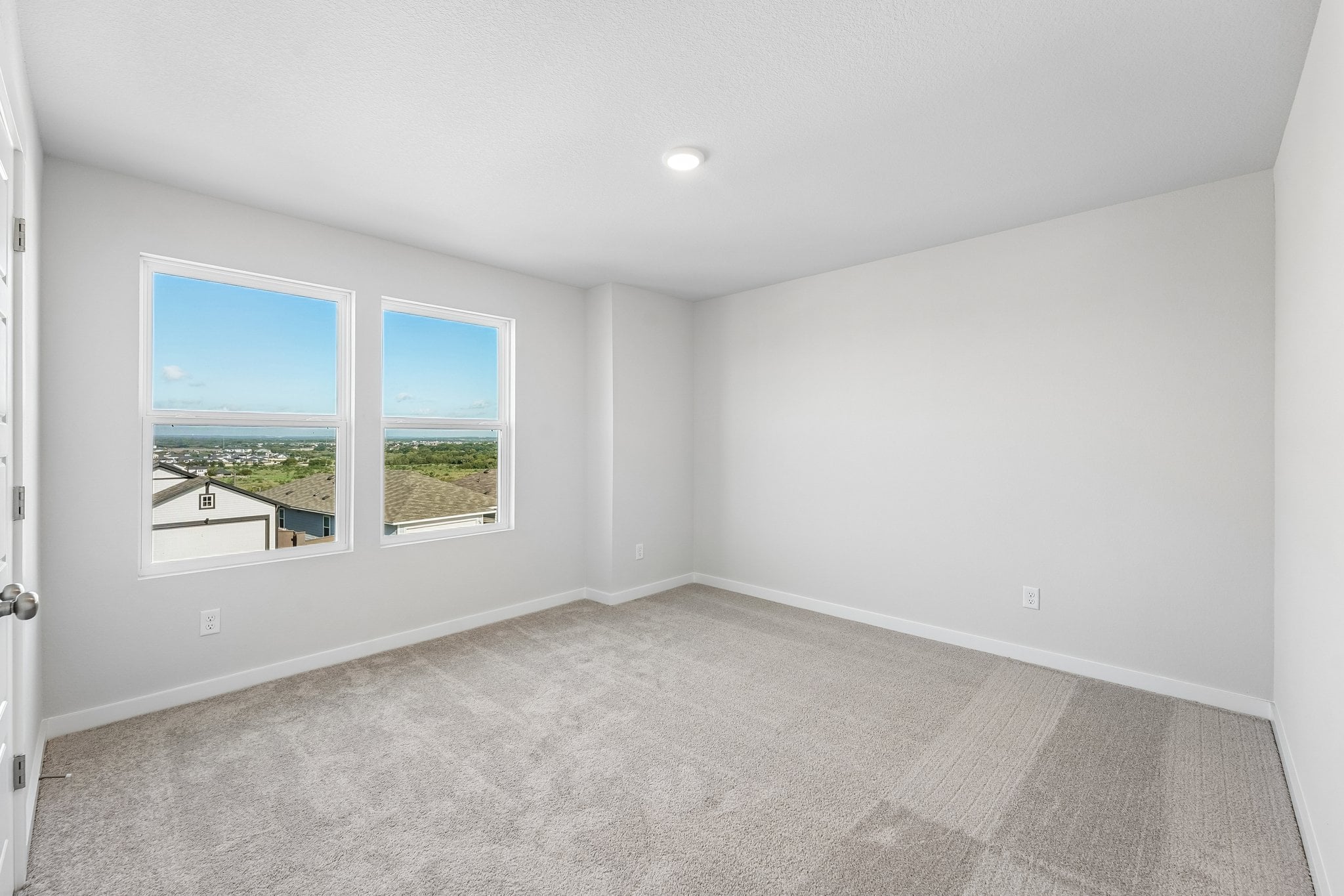 A room with a window and a carpet.