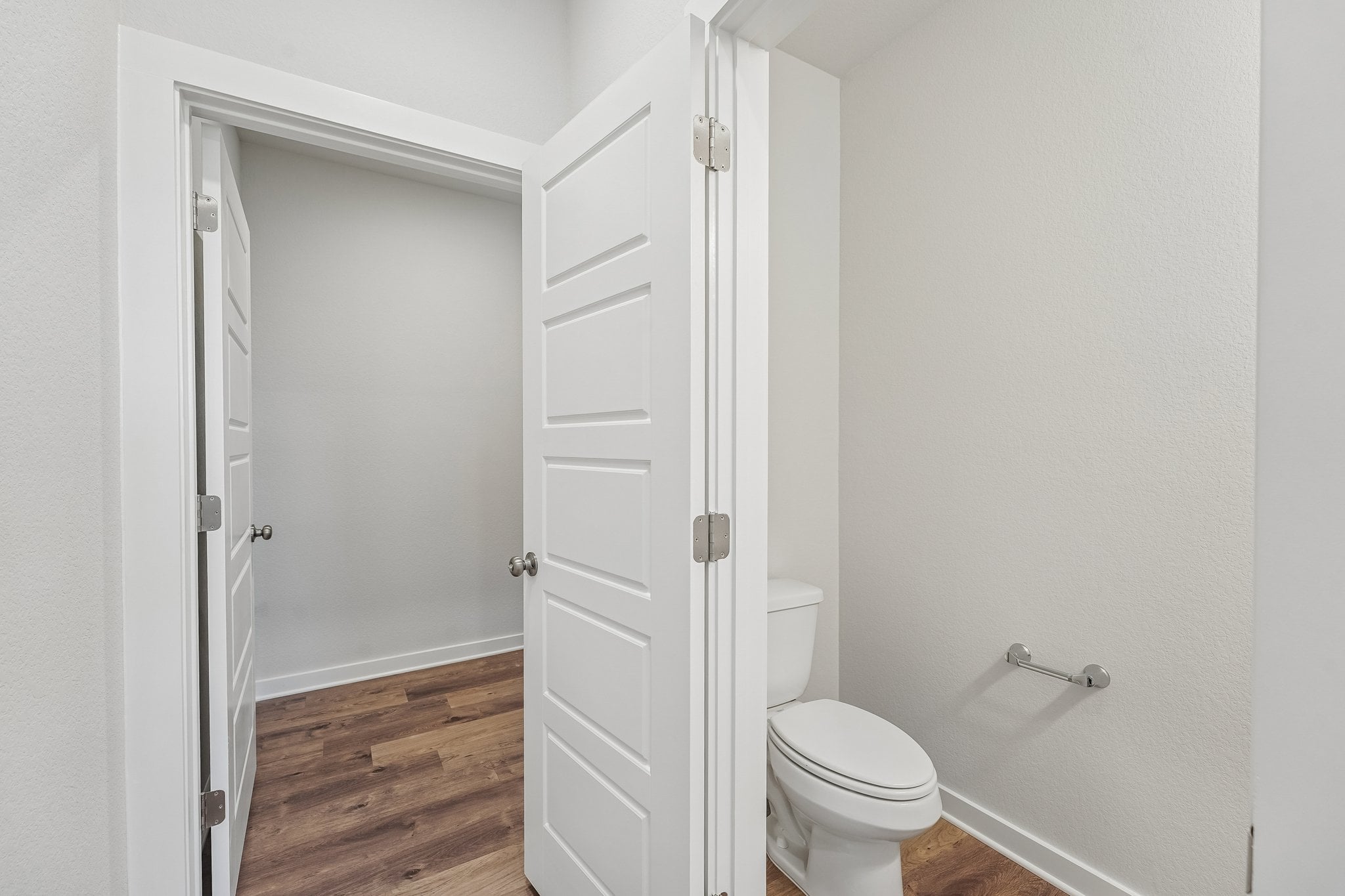 A bathroom with white cabinets.