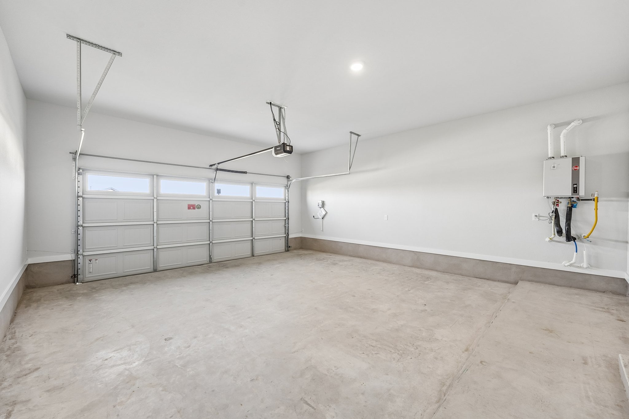 A room with a white wall and a metal gate.