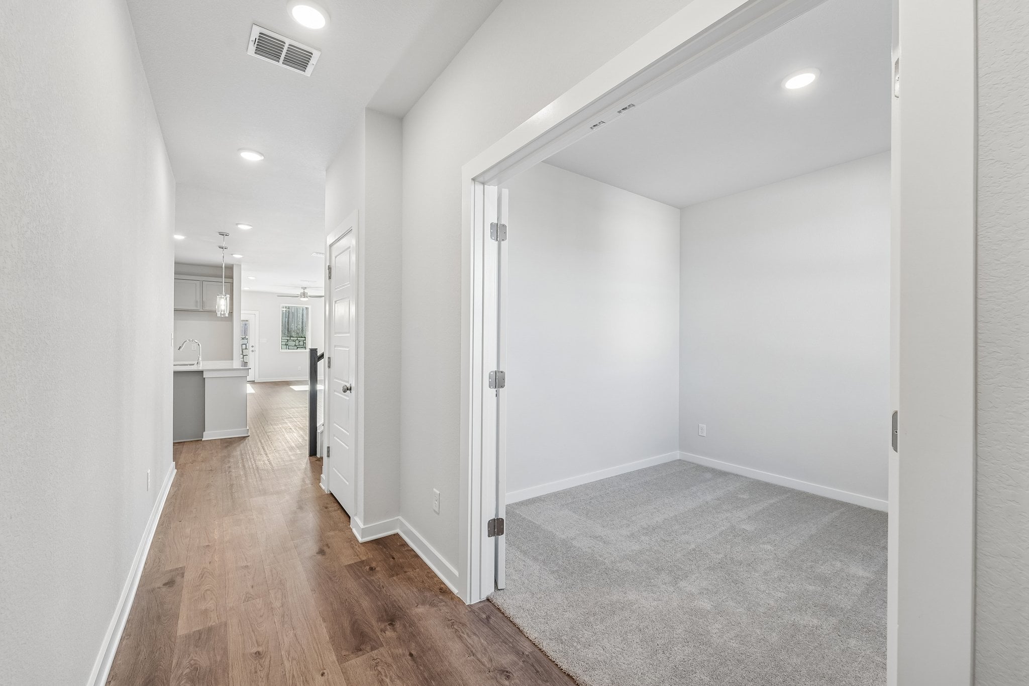 A hallway with white walls.