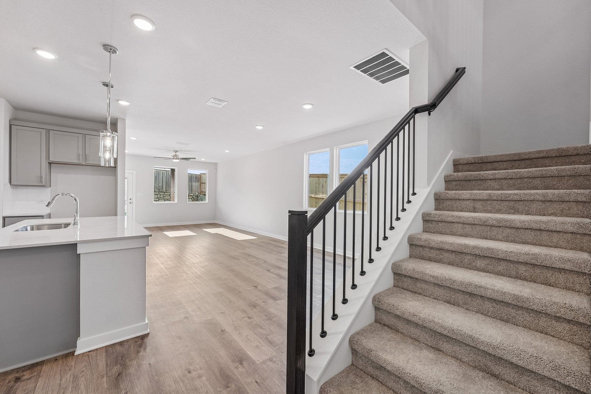 A large bathroom with a wood floor.