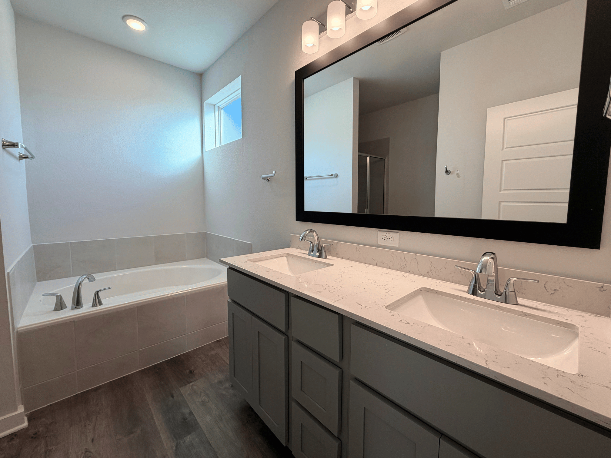 A bathroom with a large mirror.