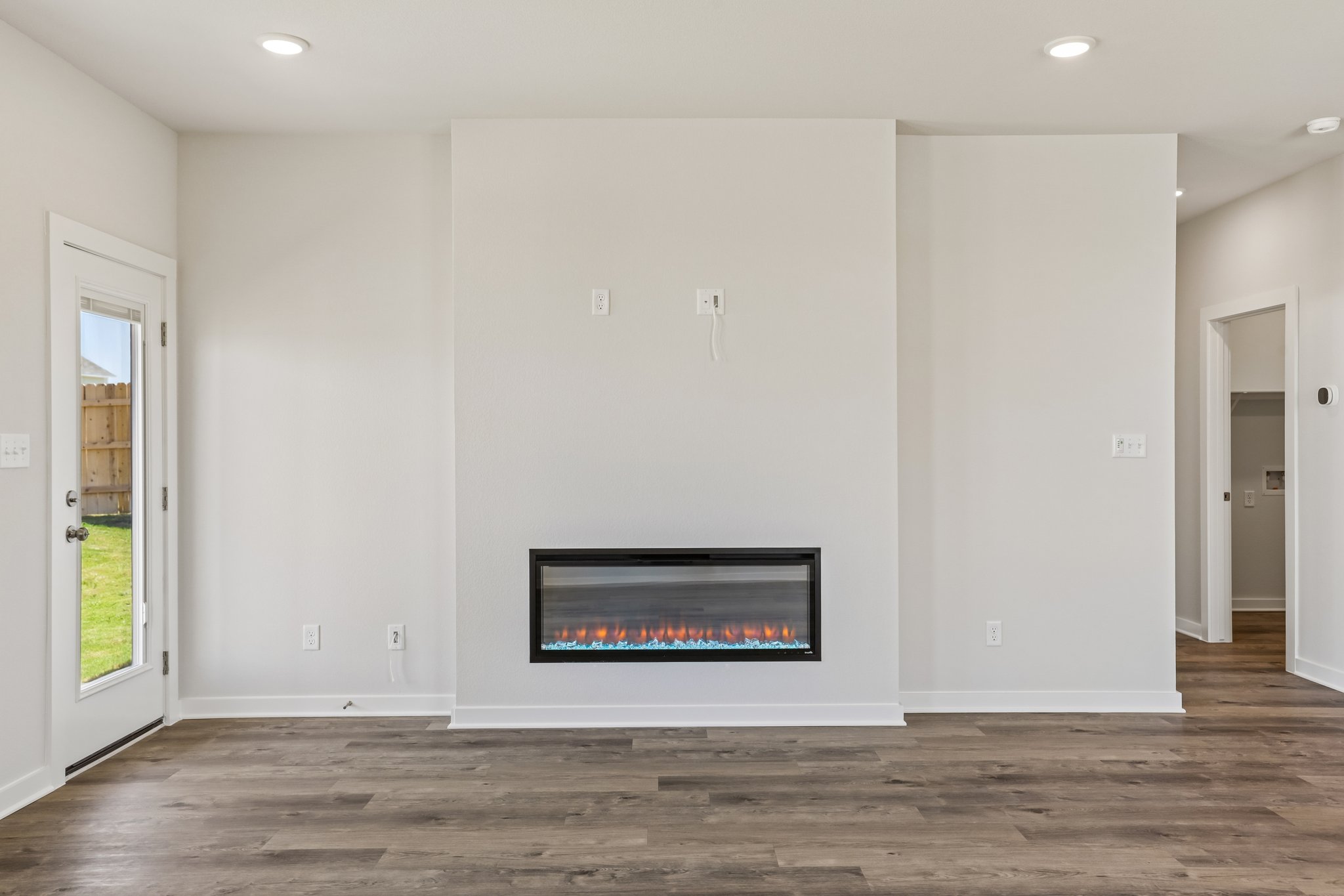 A room with a tv and a fireplace.