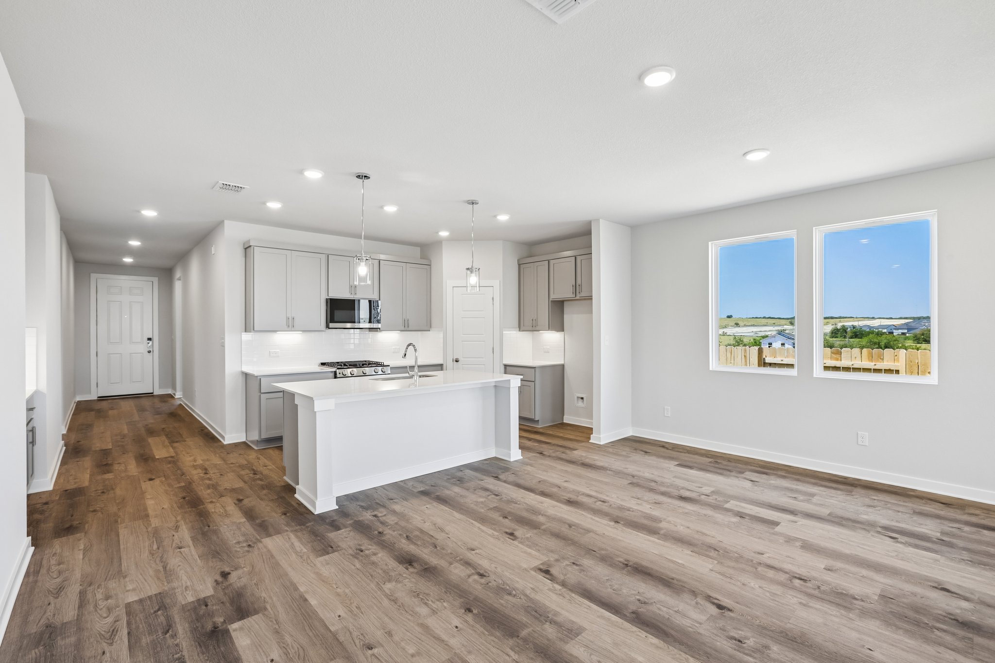 A kitchen with a wood floor.