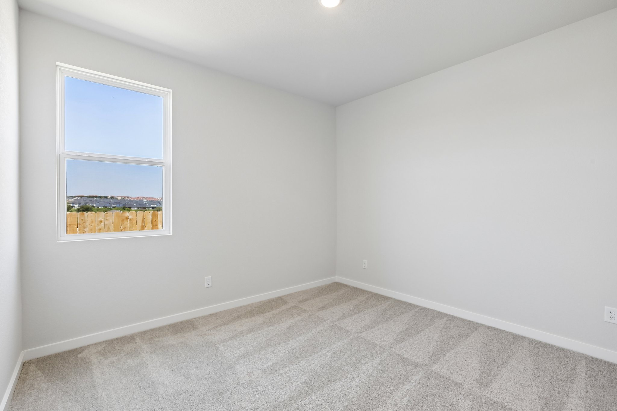 A room with a window and a tile floor.