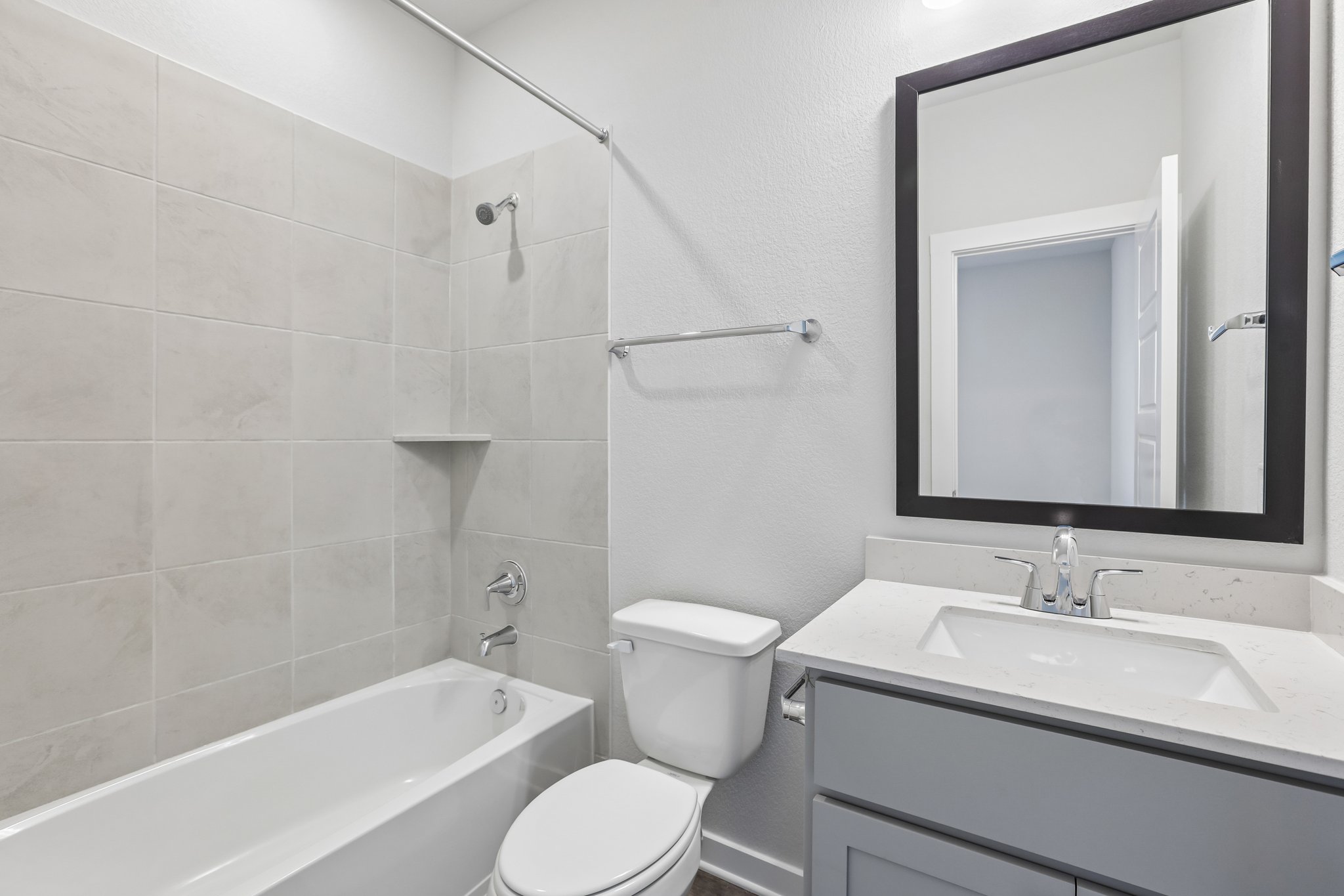 A bathroom with a tub sink and toilet.