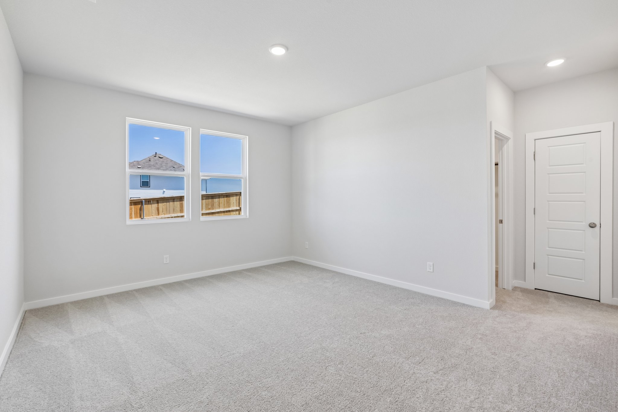 A room with white walls and a window.