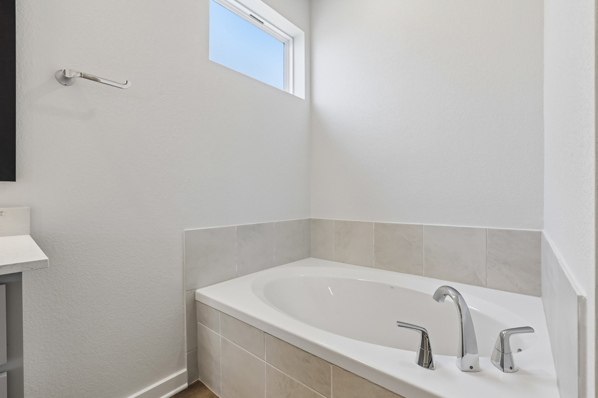 A bathtub in a bathroom.