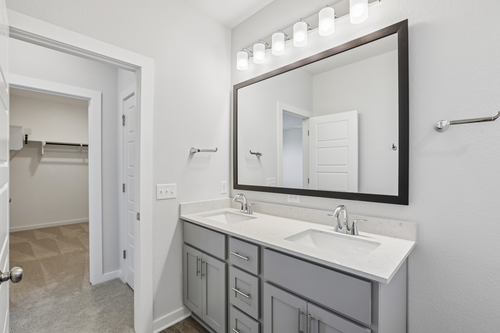 A bathroom with a large mirror.
