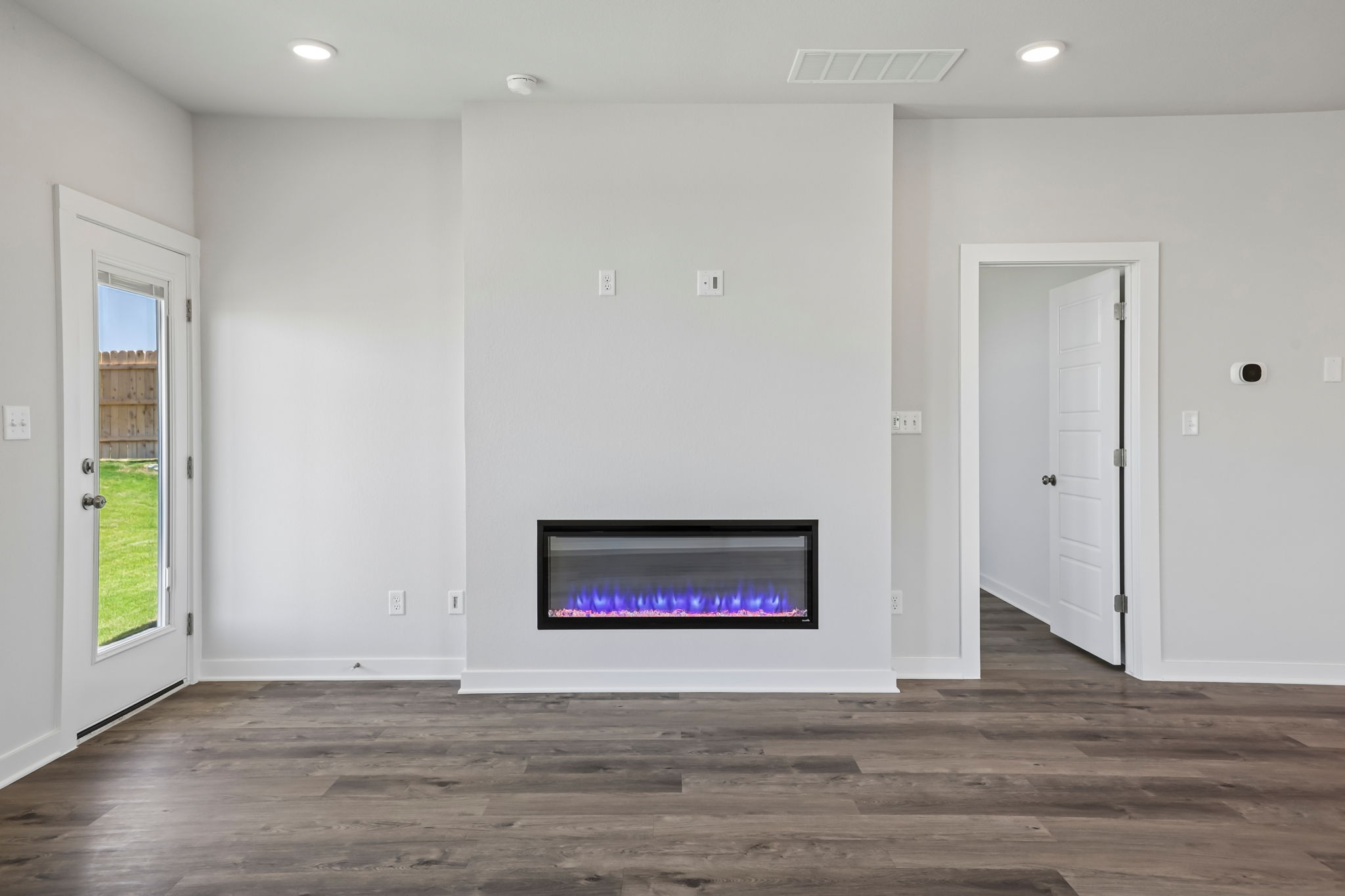 A room with a tv and white doors.