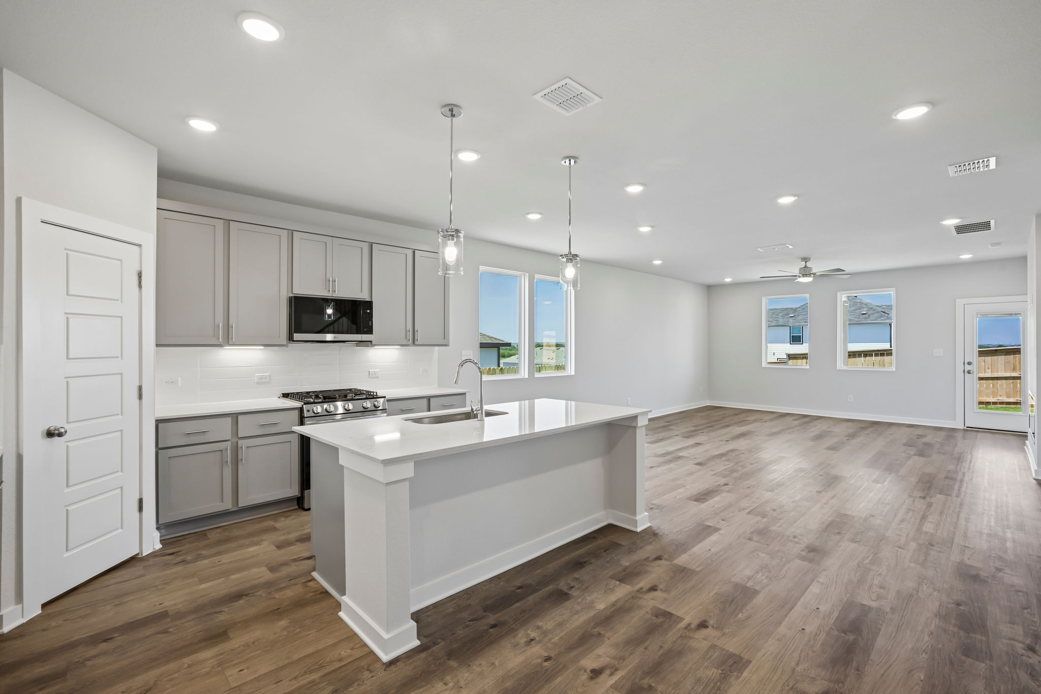 A kitchen with white cabinets.