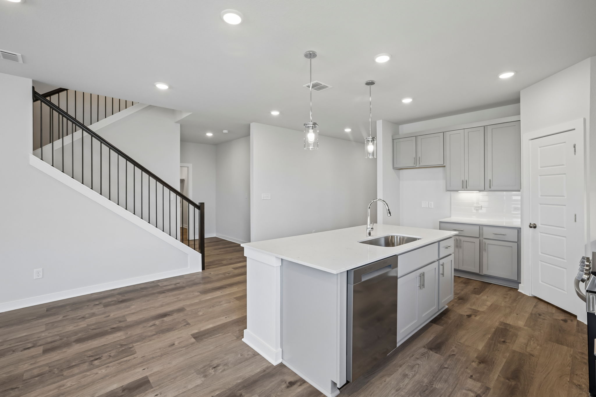 A kitchen with white cabinets.