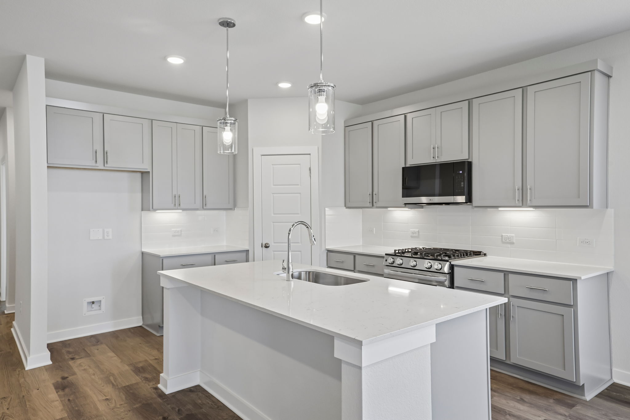 A kitchen with white cabinets.