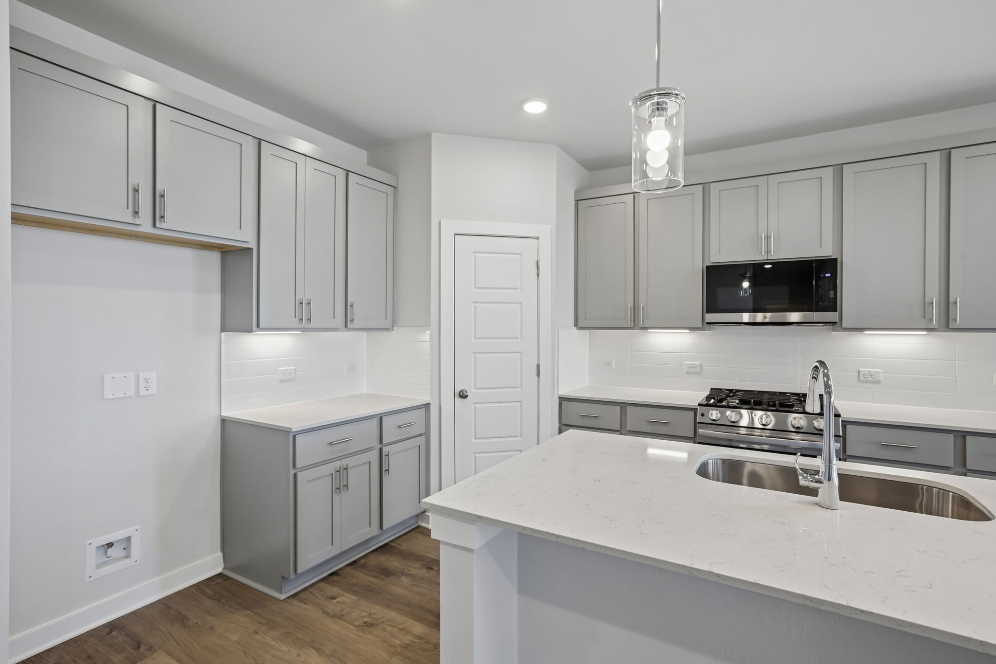 A kitchen with white cabinets.