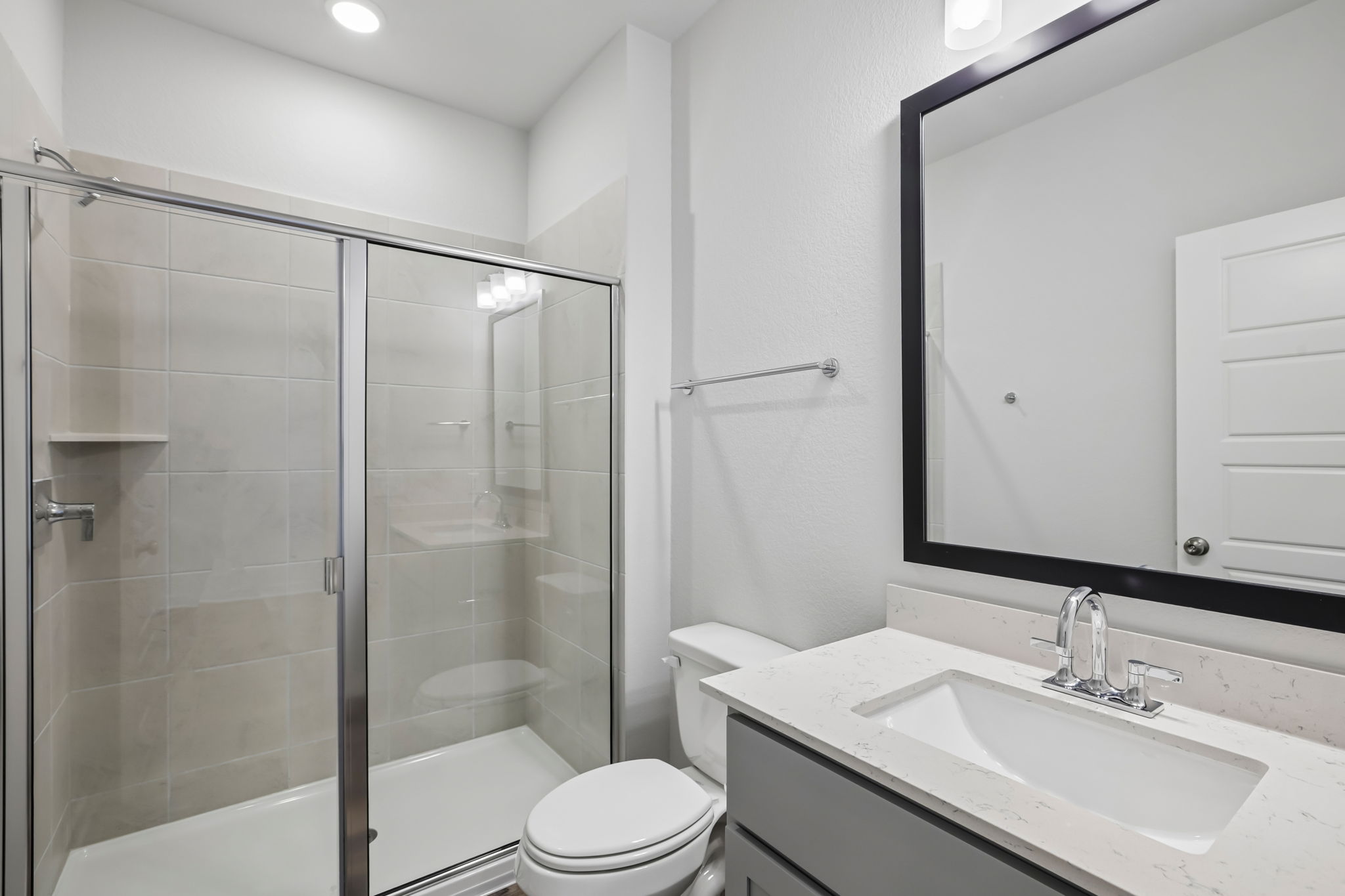 A bathroom with a glass shower.