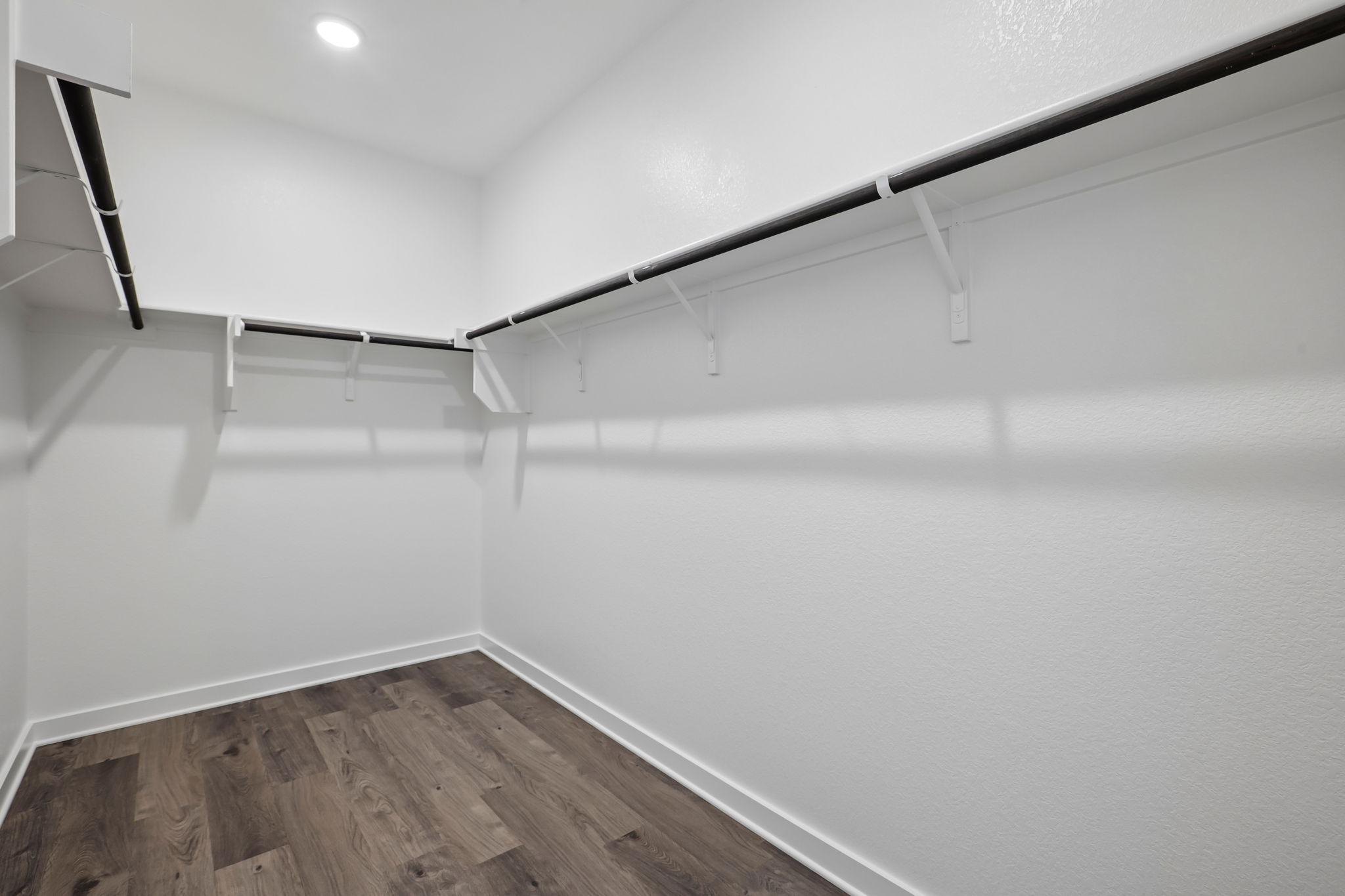 A white room with a wood floor.